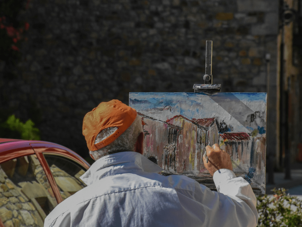 man painting a house outdoors