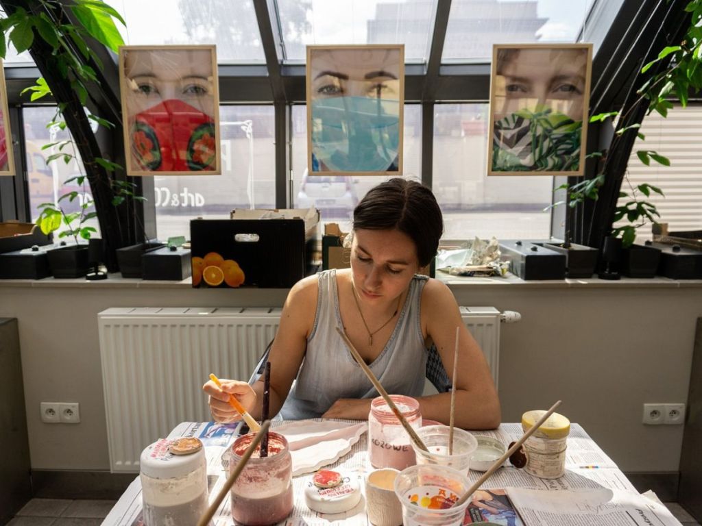 Artist painting and drawing in art studio.