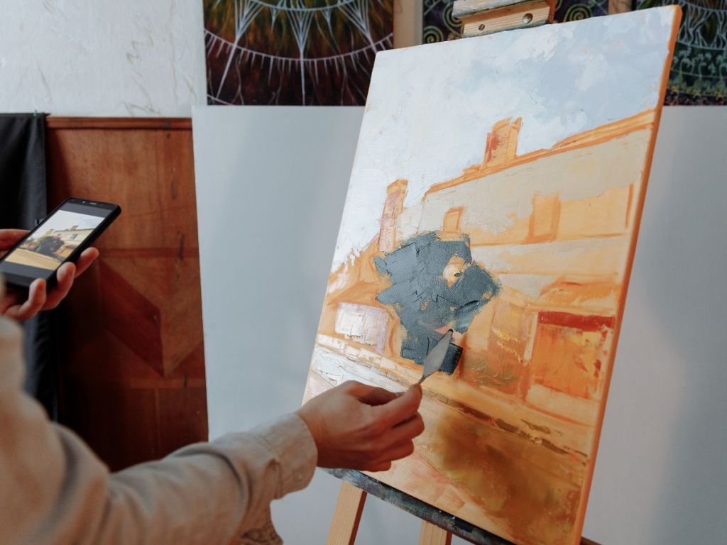 person using a palette knife in painting