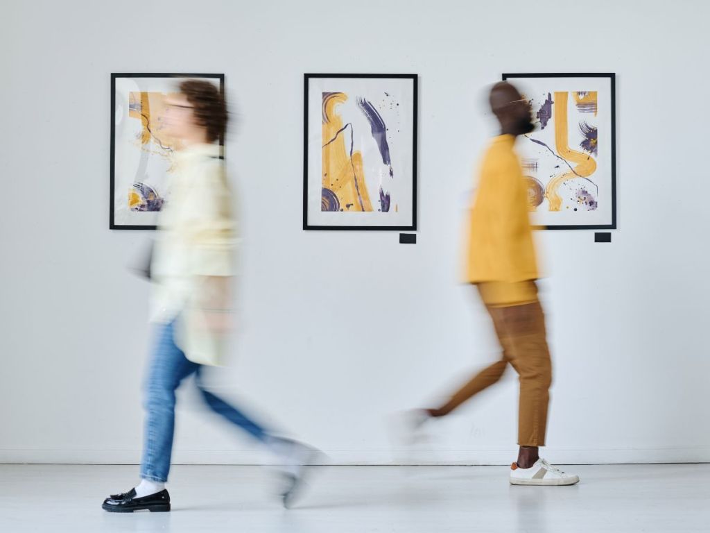 two people walking at an art gallery