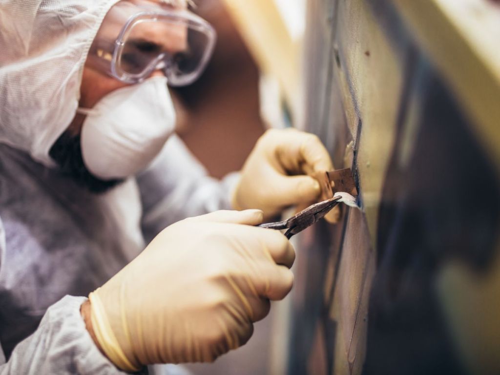 close-up of man doing art restoration