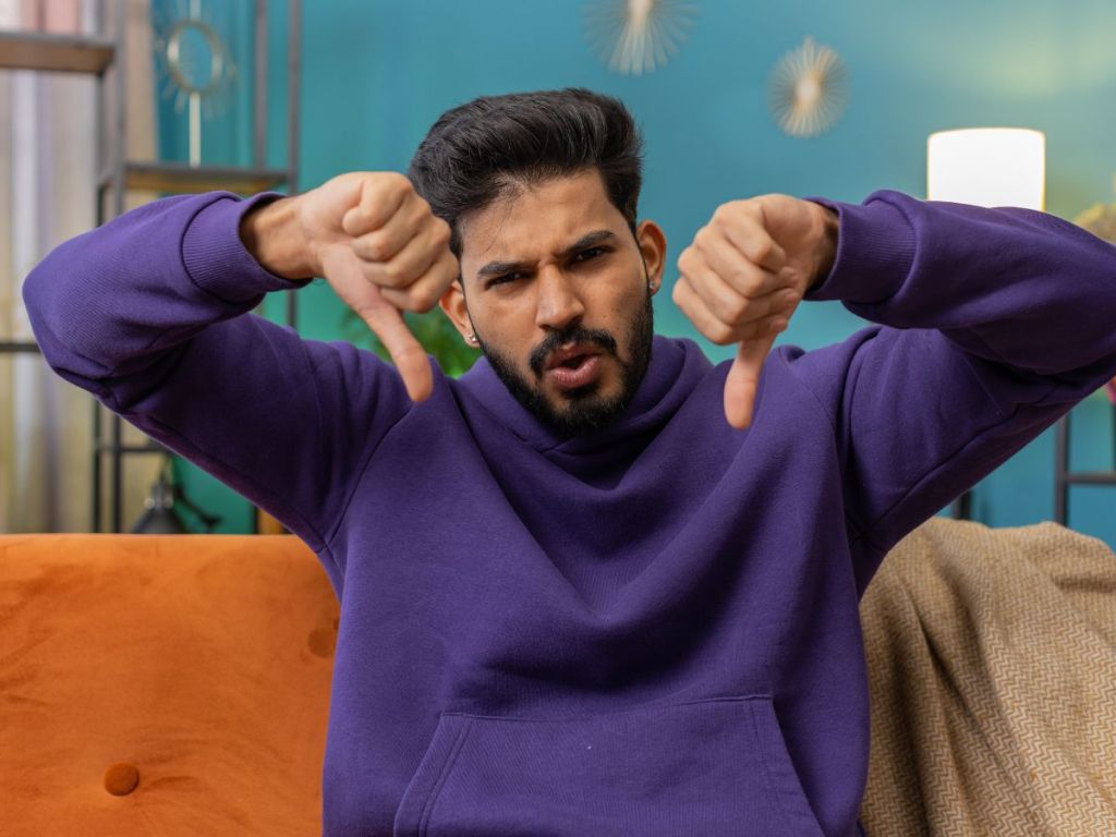 upset man showing thumbs down
