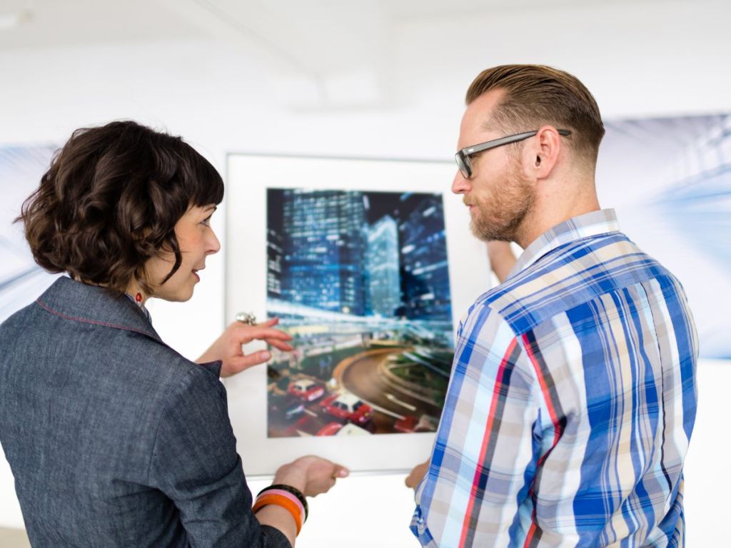 art gallery owner holding artwork