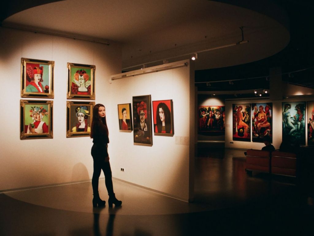 woman in an art gallery looking at contemporary paintings