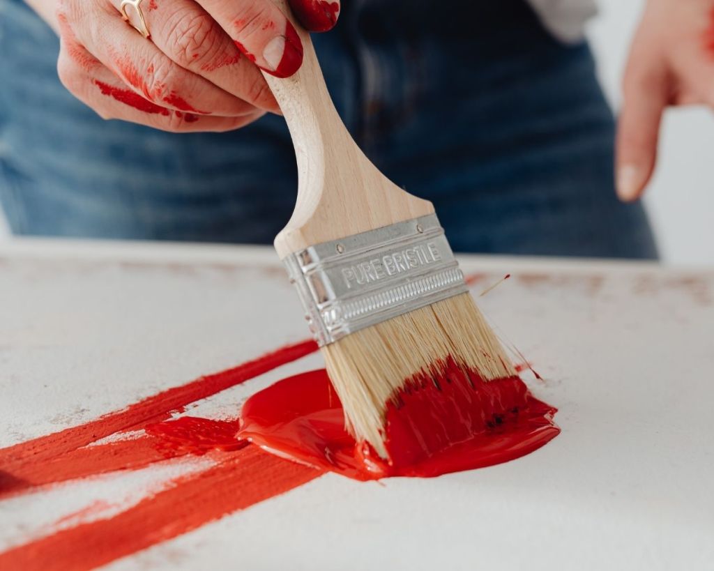 red paint on blank canvas